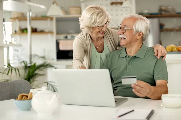 Happy Mature Couple Talking While Home Shopping Laptop Credit Card — Photo