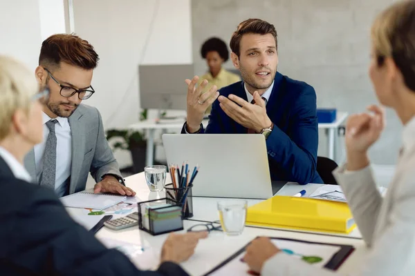 Businessman Using Laptop While Communicating Colleagues Meeting Office — Zdjęcie stockowe