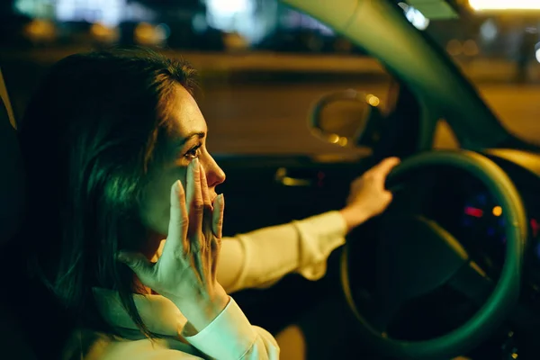 Young Crying Woman Driving Car Night Wipes Away Her Tears — Stockfoto