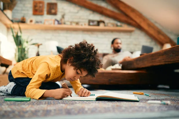 African American Little Girl Drawing Paper While Sitting Floor Home — Foto de Stock