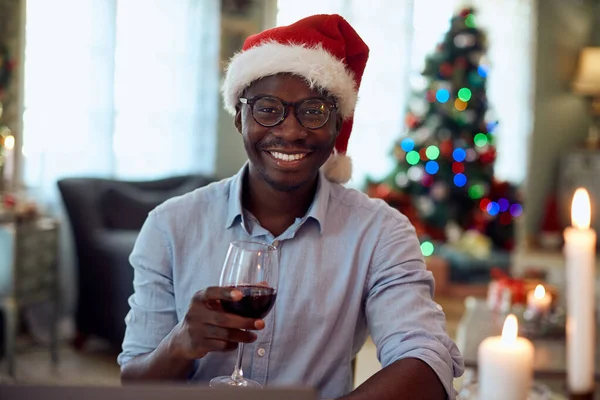 Portrait Happy African American Man Celebrating Christmas Drinking Wine Home — Stock fotografie