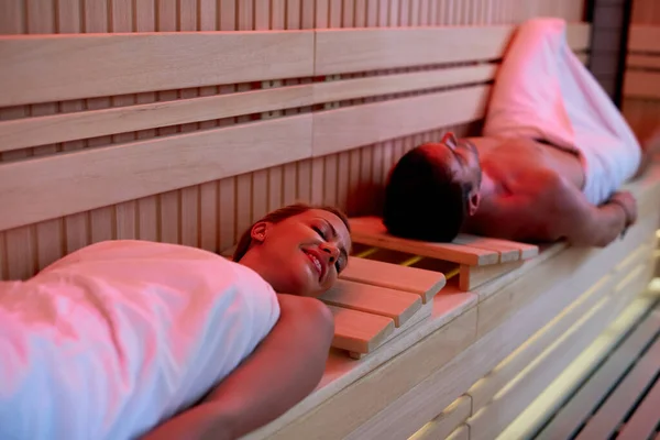 Smiling Couple Relaxing Eyes Closed While Lying Sauna Spa Focus — стоковое фото