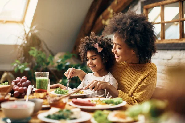Happy Black Girl Sitting Mother Lap While Having Meal Dining — Foto de Stock