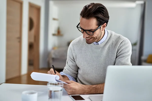 Happy Businessman Writing Notes While Working Computer Home — Stockfoto