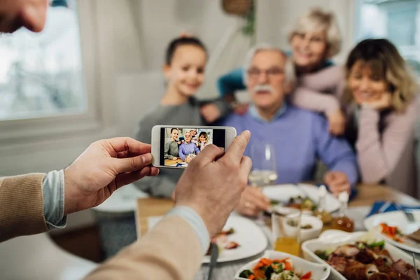 Close Man Using Smart Phone While Photographing His Extended Family — Foto Stock