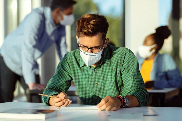 Male Student Wearing Protective Face Mask While Having Exam Lecture — Stock Photo, Image