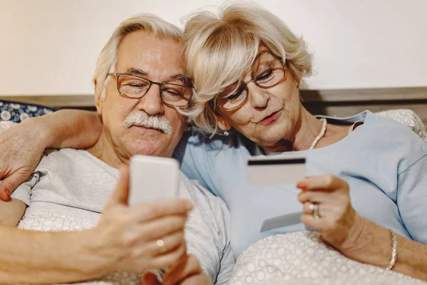 Embraced Senior Couple Lying Bed Buying Internet Credit Card Smart — Photo