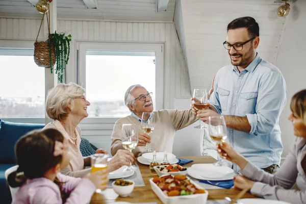 Happy Multi Generation Family Toasting Meal Dining Room Focus Senior — Zdjęcie stockowe