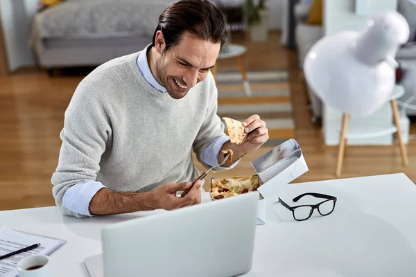 Young Happy Businessman Eating While Surfing Net Computer Working Home — Stockfoto