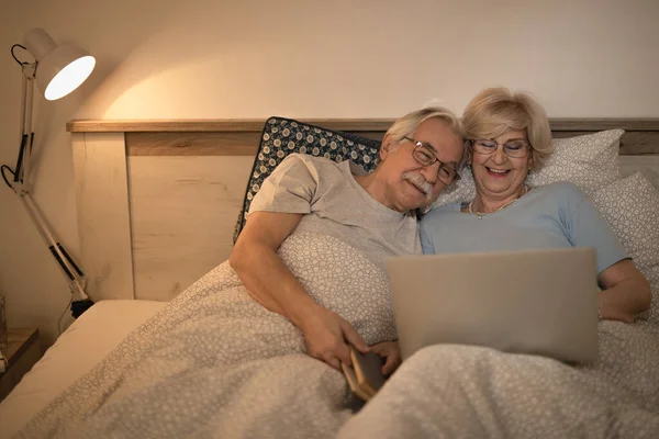 Happy Mature Couple Using Laptop While Resting Bed Evening — Photo