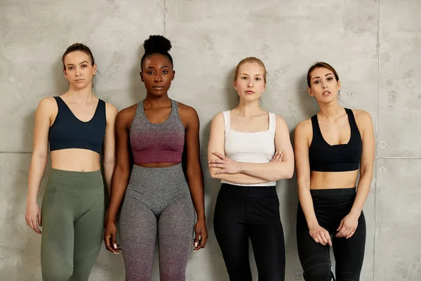 Portrait of multi-ethnic group of young athletic women looking at camera.