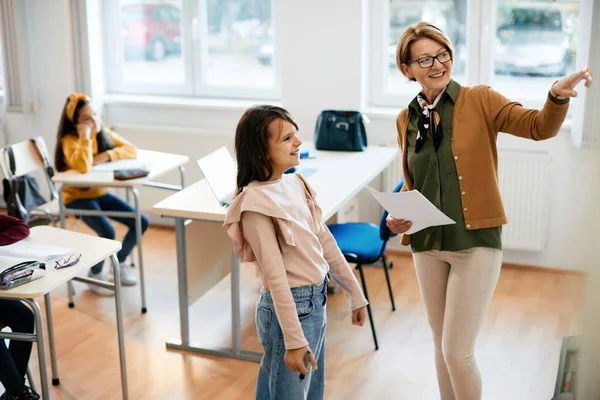 Happy Mature Teacher Explaining Schoolgirl Assignment Whiteboard Class Elementary School — Stock Fotó
