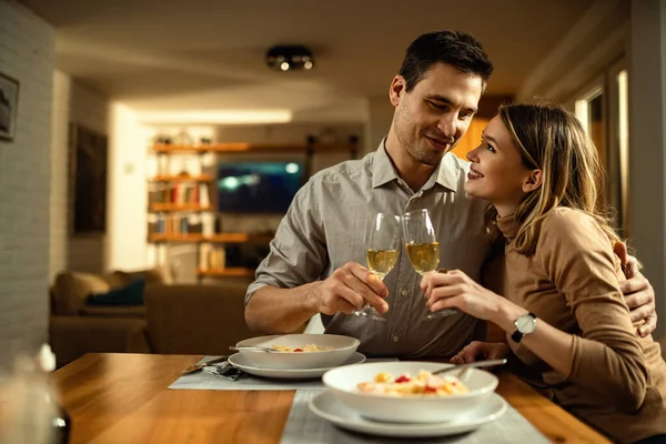 Happy Couple Love Toasting Champagne While Embracing Dining Table — стокове фото