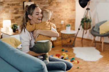Affectionate mother and son embracing while spending time at home. 