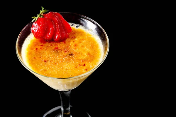 Lemon sorbet with strawberry in martini glass.