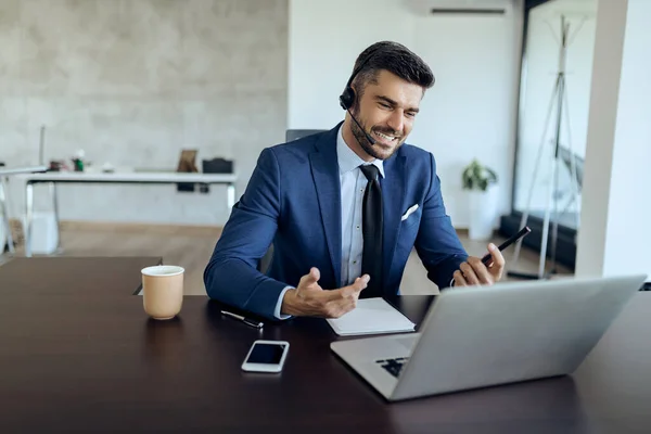 Happy Businessman Using Computer Talking Someone While Having Video Call — kuvapankkivalokuva