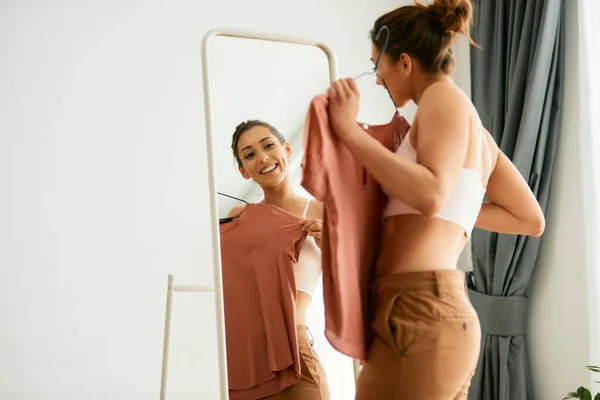 Young Happy Woman Choosing Clothing Looking Herself Mirror Home — Φωτογραφία Αρχείου