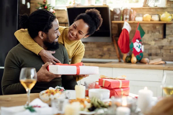 Happy African American Woman Surprising Her Husband Christmas Present — ストック写真