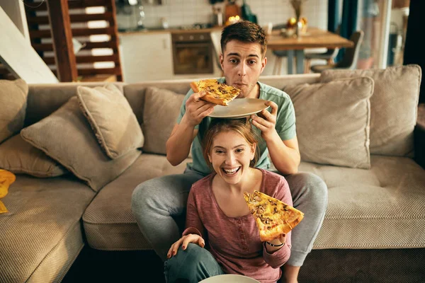 Happy Woman Having Fun While Eating Pizza Watching Her Boyfriend — Stockfoto