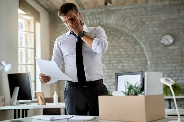 Mid Adult Businessman Feeling Worried While Reading Notice His Dismissal — ストック写真