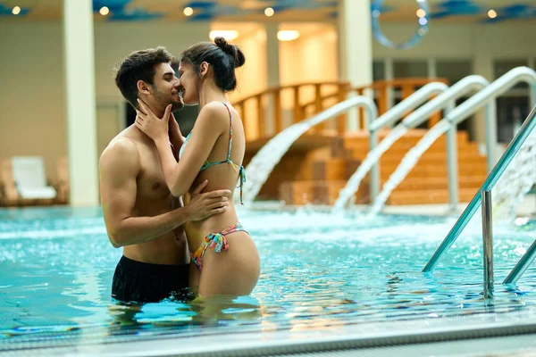 Young Loving Couple Kissing While Being Pool Wellness Center — стоковое фото