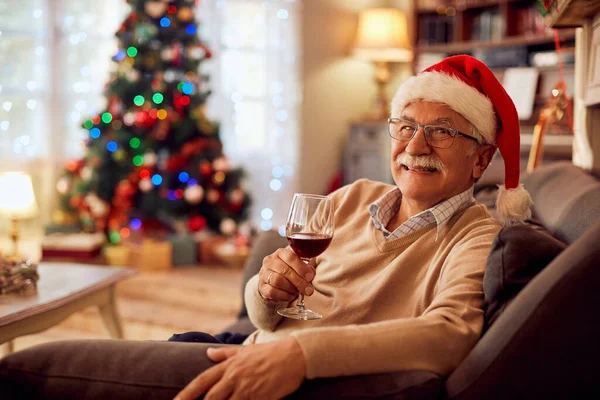 Happy Mature Man Wearing Santa Hat While Drinking Wine Christmas — ストック写真