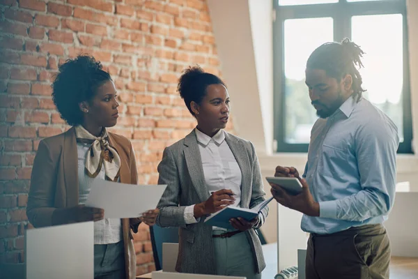 African American businesswoman talking to her team during a meeting in the office.