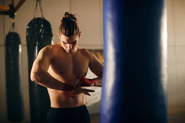 Young Boxer Bandaging Fists Red Straps Exercising Health Club — Zdjęcie stockowe