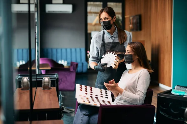 Happy Hairstylist Her Customer Choosing Hair Dye While Wearing Protective — Zdjęcie stockowe