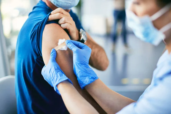 Close Healthcare Worker Putting Adhesive Bandage Patient Arm Giving Him — Foto de Stock