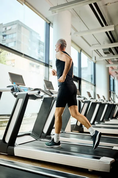 Low Angle View Mature Sportsman Jogging Treadmill While Exercising Gym — Fotografia de Stock