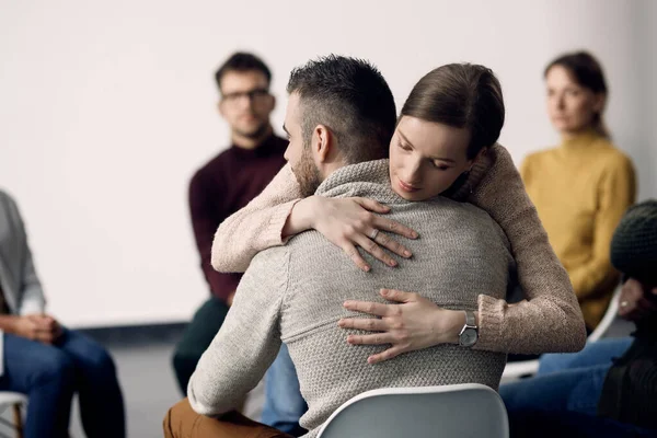 Young Woman Embracing One Attenders Group Therapy Meeting — Stock Fotó