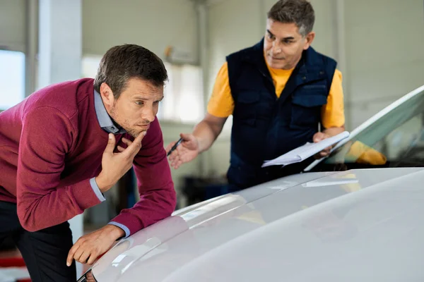 Uncertain Man Examining His Car Hood While Mechanic Talking His — ストック写真