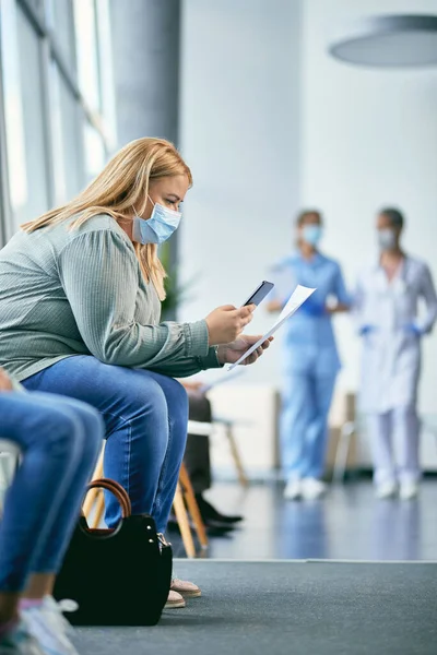 Woman Text Messaging Mobile Phone While Waiting Medical Exam Sitting — 스톡 사진