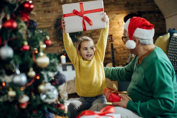 Happy Little Girl Getting Present Grandfather Having Fun Christmas Day — Zdjęcie stockowe