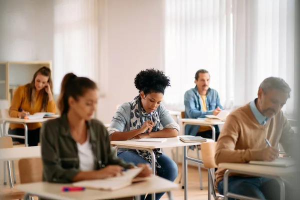 African American Adult Student Her Classmates Doing Exam Classroom Copy — Fotografia de Stock