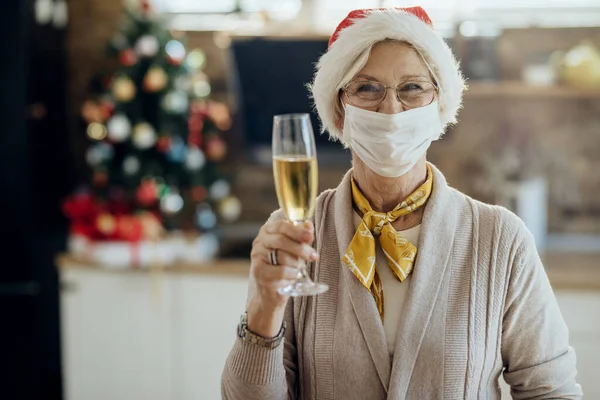 Happy Mature Woman Toasting Glass Champagne Christmas While Wearing Protective — ストック写真
