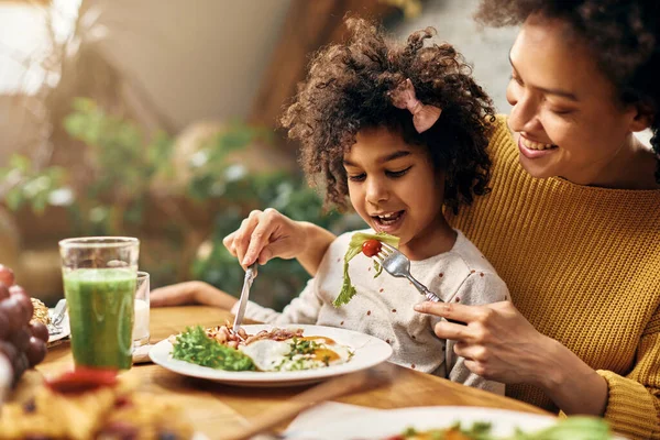 Happy African American Girl Sitting Mother Lap While She Feeding — Foto de Stock