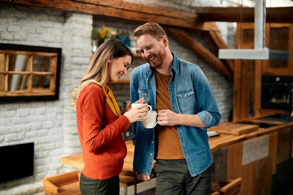 Happy Couple Enjoying While Communicating Drinking Coffee Home — стоковое фото