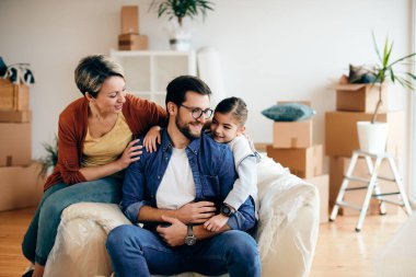Happy family enjoying while relocating into a new house. 