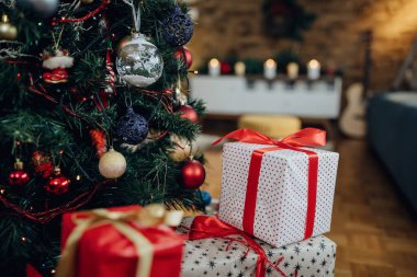 Close-up of presents by Christmas tree at home. 