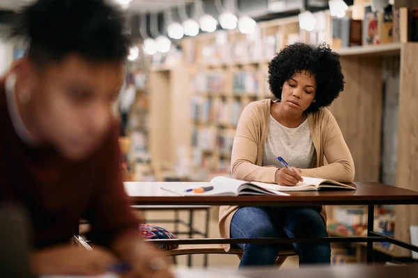 African American Female Student Taking Notes While Learning Library — Fotografia de Stock