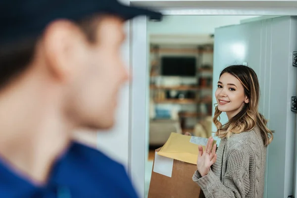 Smiling Woman Holding Packages Waving Goodbye Courier While Standing Doorway — Stok Foto