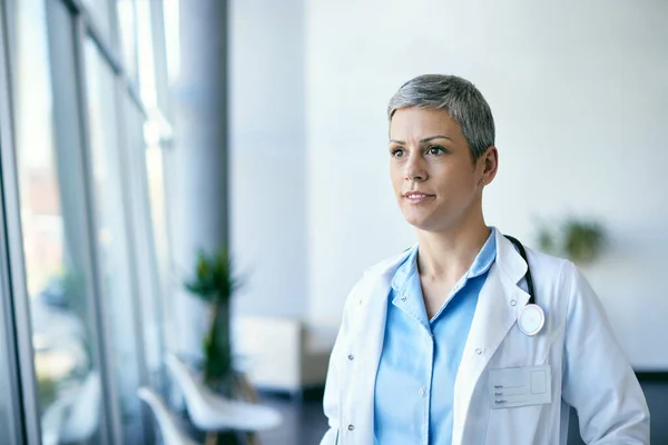 Smiling Female General Practitioner Standing Hospital Hallway Looking Away — Foto de Stock