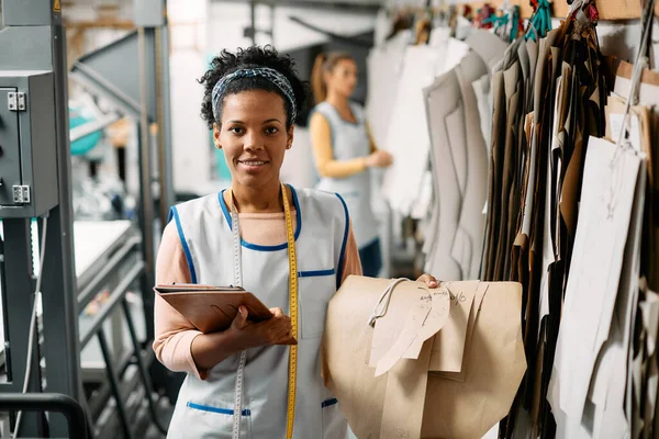 Happy African American Dressmaker Holding Clothing Paper Patterns Digital Tablet — Zdjęcie stockowe