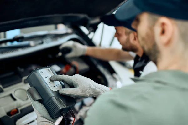 Close Car Mechanic His Coworker Using Diagnostic Tool While Examining — Stock fotografie