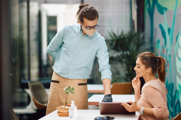 Waiter Advising Female Guest Choosing Order Restaurant Menu While Wearing —  Fotos de Stock