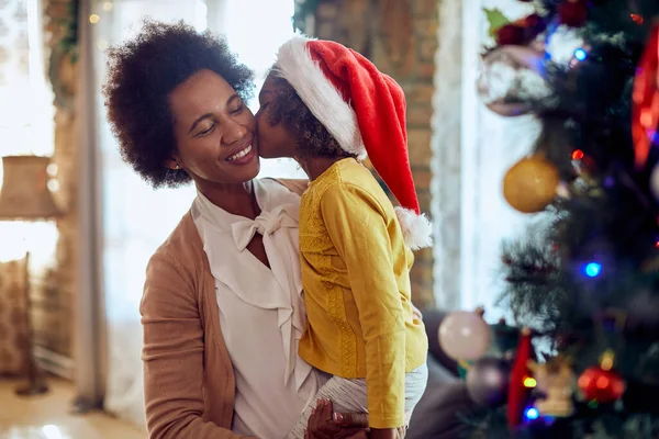 Happy Black Mother Holding Her Small Daughter Who Kissing Her — ストック写真