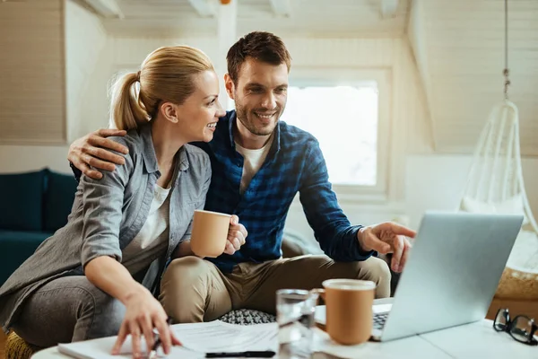 Young Happy Couple Talking While Drinking Coffee Working Computer Home — Foto de Stock