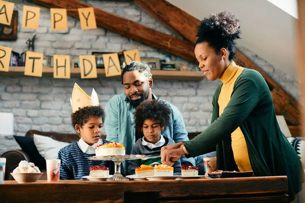 Happy African American Mother Serving Cake Son Birthday Party Home — Foto de Stock